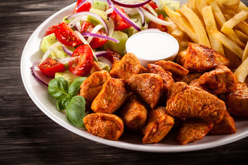 Fried chicken nuggets, French fries and vegetables