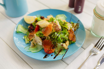 Healthy restaurant food, salmon and cod fish salad closeup