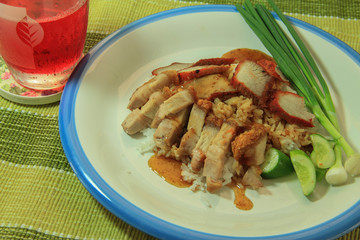 Thai food Barbecued red pork and crispy pork in sauce with rice and sweet drink