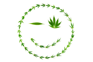 Winking face as smiley made of hemp leaves