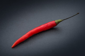 Red hot chili pepper on a dark background.
