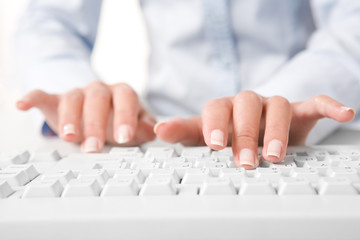 Photo of human fingers pushing the buttons of keyboard