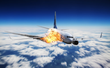 Plane flying in sky with engine on fire
