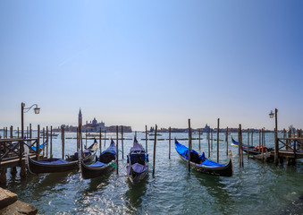 Gondolas on the background of the lagoon and the San Giorgio Maggiore island of Venice