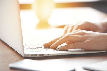 Close-up photo of neat and elegant hands of woman during work on the digital device. Inspiring...