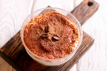 Traditional Italian dessert tiramisu in a glass, top view