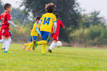 Obraz premium Boys kicking ball