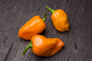 some vegetable of orange chili pepper habanero on wooden vintage