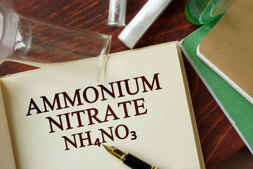 Word ammonium nitrate written on a page. Chemistry concept.