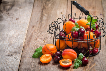  Apricots and cherries on rustic  background