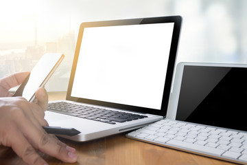 man of business man hand working on laptop computer on wooden de