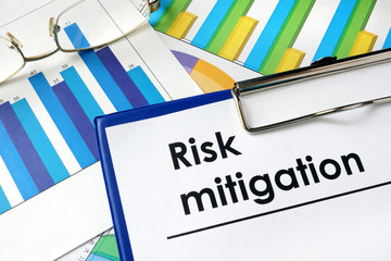 Paper with words Risk mitigation and charts.