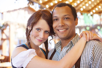 In love interracial couple enjoying Oktoberfest