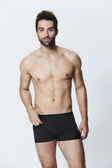 Fototapeta na wymiar Man in black underwear shorts, portrait
