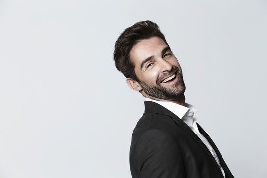 Carefree man in suit, laughing