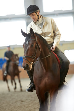 A jockey training a horse before the race