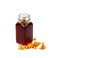 Sea buckthorn oil and berries on white background