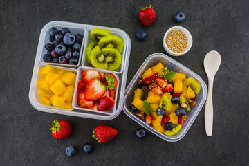 Tasty raw fruits in plastic lunch box. Bento box. Take away food. Vegetarian food. 