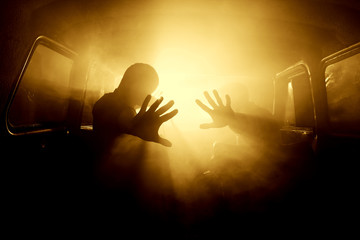 silhouettes of passengers in the car full of smoke