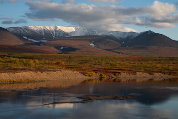 Autumn mountains across the river. Polar Urals. Sob River. Russia.