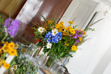 Wild flower colorful bouquet decoration arrangement wedding celebration bank rustic vase indoor background