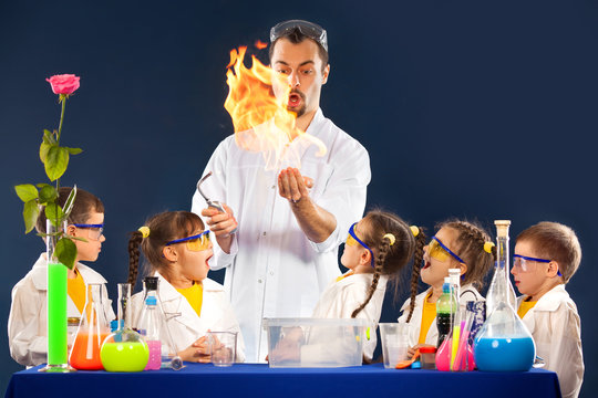 Group kids and scientist doing experiments with fire in laboratory