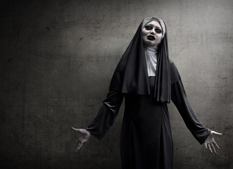 Asian woman dressed in evil nun - obrazy, fototapety, plakaty