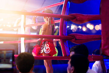 Martial arts of Muay Thai boxer kids with items in boxing ring