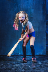 Halloween theme: Girl with baseball bat ready to hit