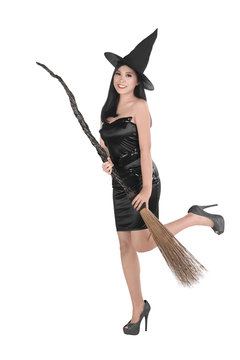 Beautiful asian witch woman with hat holding broom