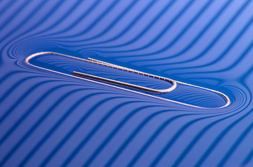 Surface tension - paperclip on water surface macro, in striped lighting, not photoshopped, simple...