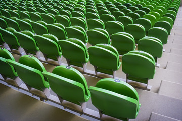 Obraz premium Seating rows in a stadium with weathered chairs