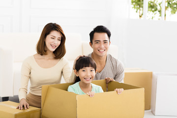 happy family holding box moving to new home