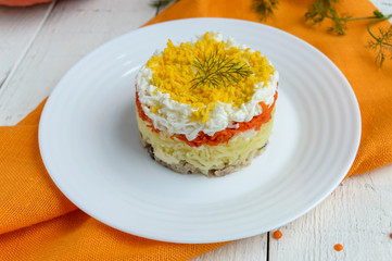 Easy Diet salad layers in the shape of a circle (tuna in oil, boiled potatoes, carrots, eggs). Alternative Slavonic traditional dish 