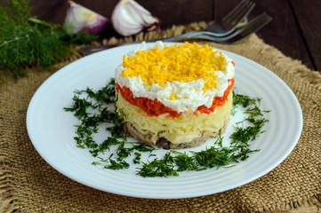 Easy Diet salad layers in the shape of a circle (tuna in oil, boiled potatoes, carrots, eggs). Alternative Slavonic traditional dish 