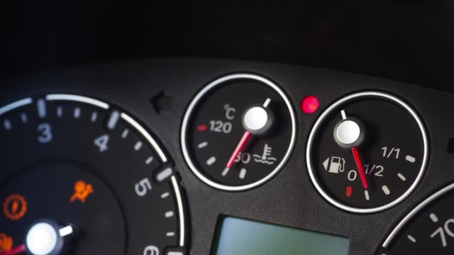 Color close up footage of a car's dashboard, with engine stopping.