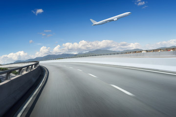 Fototapeta na wymiar Highway overpass motion blur with blue sky and aeroplane .
