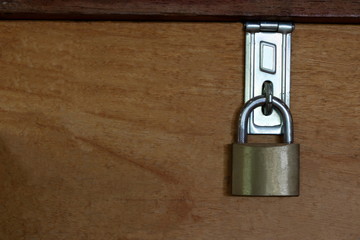 Fototapeta premium Master key is lock on wood background, blank on left background for message
