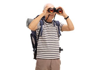 Mature male hiker looking through binoculars