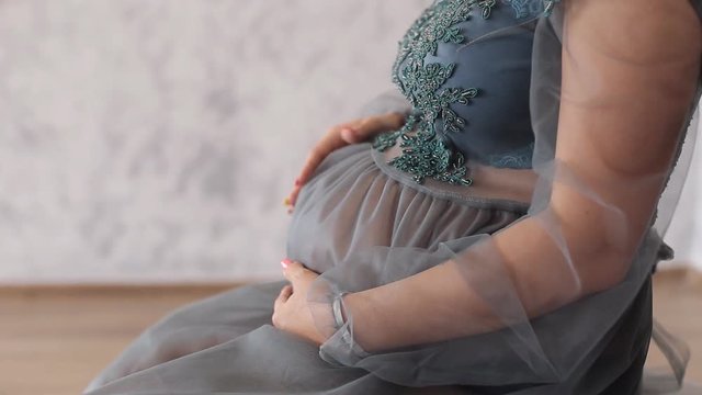 Close up of pregnant woman sitting in chair