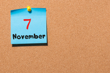 November 7th. Day 7 of month, color sticker calendar on notice board. Autumn time. Empty space for text