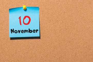 November 10th. Day 10 of month, color sticker calendar on notice board. Autumn time. Empty space...
