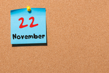 November 22nd. Day 22 of month, color sticker calendar on notice board. Autumn time. Empty space...