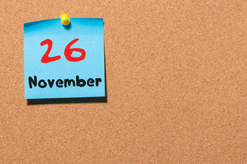 November 26th. Day 26 of month, color sticker calendar on notice board. Autumn time. Empty space for text