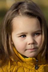 Fototapeta premium Portrait of a girl in a park close-up