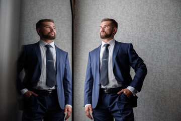 young businessman on grey background