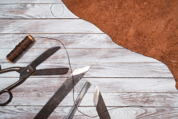 A lot of work tools and leather for shoemaker.Leather craft. Copy space.