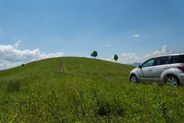 Obraz na płótnie Canvas hills meadows road car
