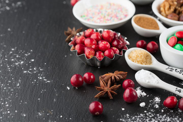 Christmas baking cupcake decorations and sprinkles, black background. Holiday concept, winter time