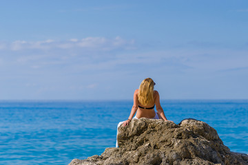 Fototapeta na wymiar woman relaxing on the beach in Greece